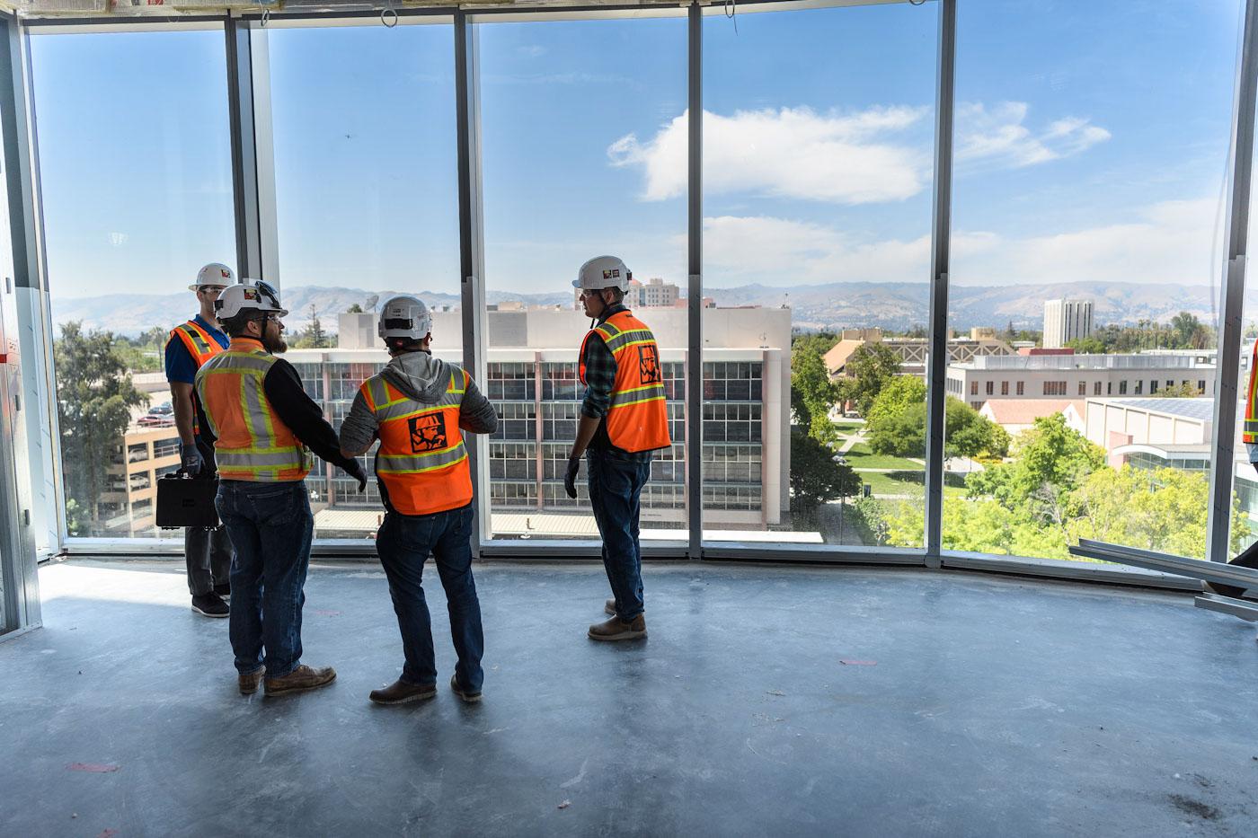 construction workers looking out from building