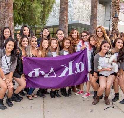 Sorority students with banner