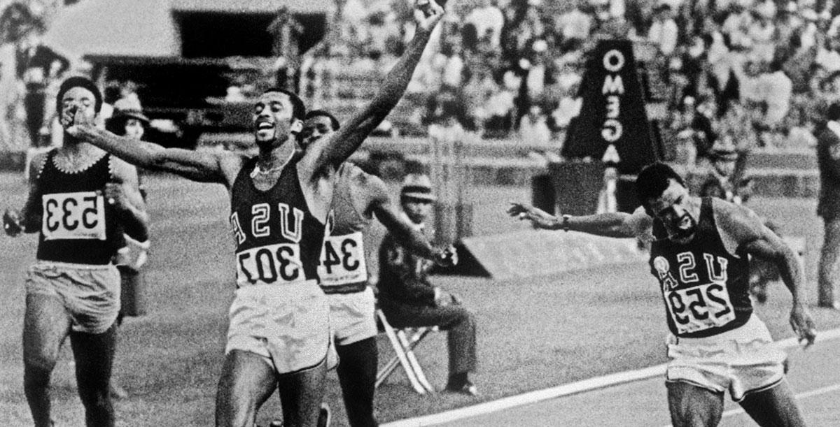 Tommie Smith reaching the finish line at the Olympics.